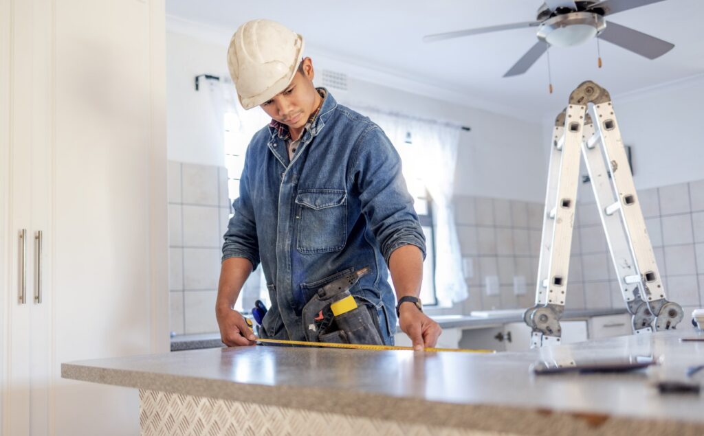 Construction, measurement and handyman doing home repair, renovation and building a counter.